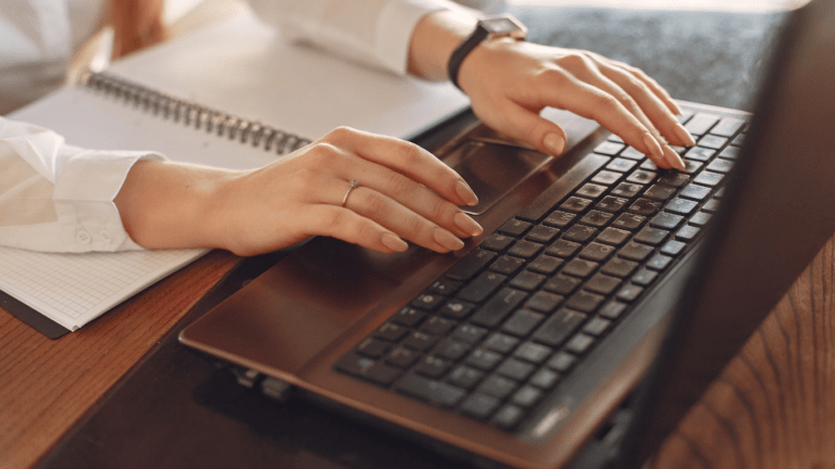 a person typing on a laptop computer