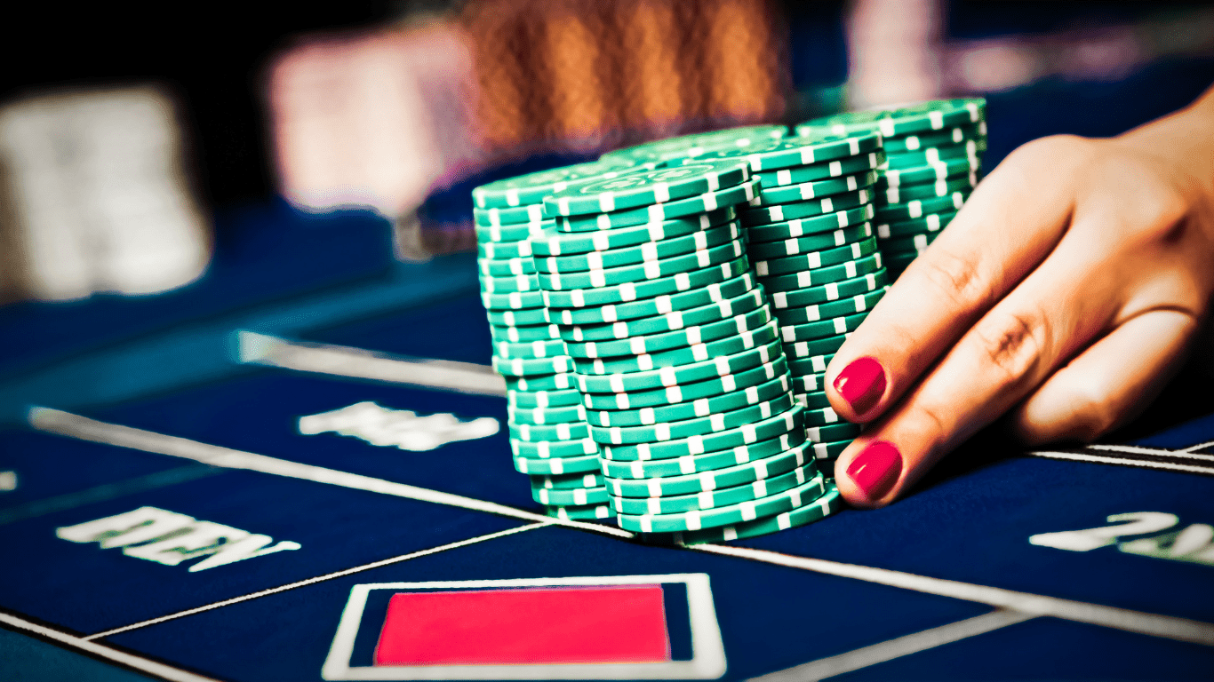 a person hand holding a casino chips