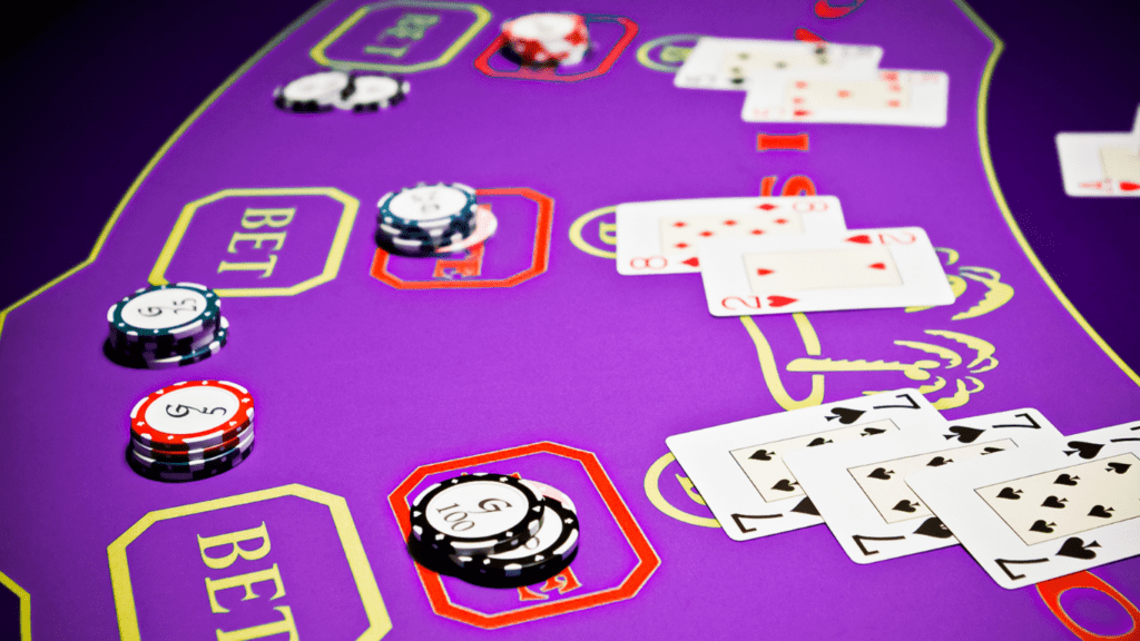 a casino table with several cards and chips on it