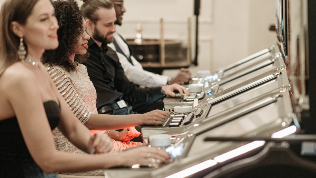 a group of people playing slot machines in a casino