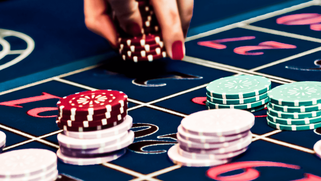 a person hand holding a casino chips