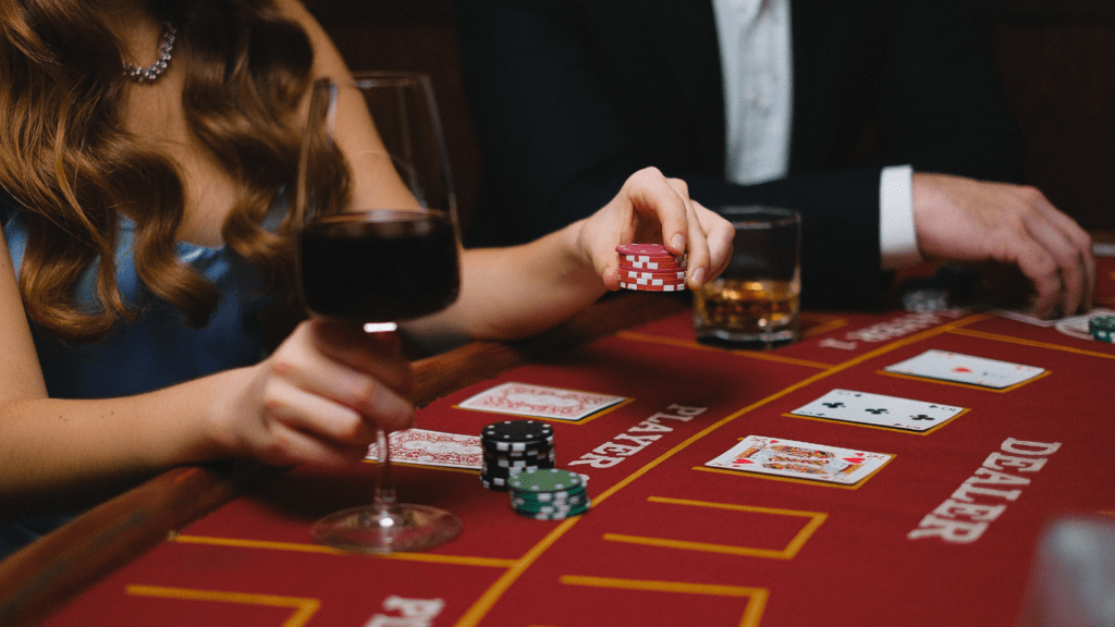 two individuals in suits playing blackjack at a casino table