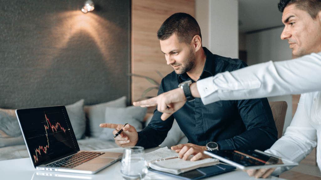 two professional guy reading trading chart