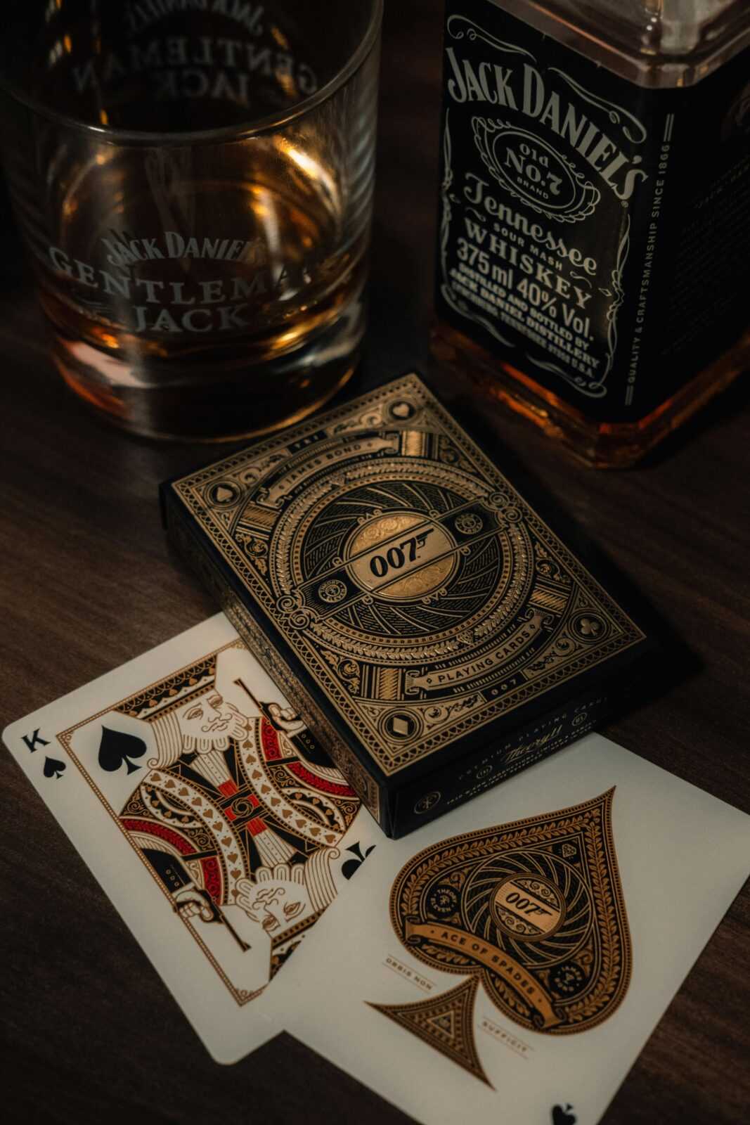 Stylish display of whiskey and playing cards creates an elegant ambiance indoors.